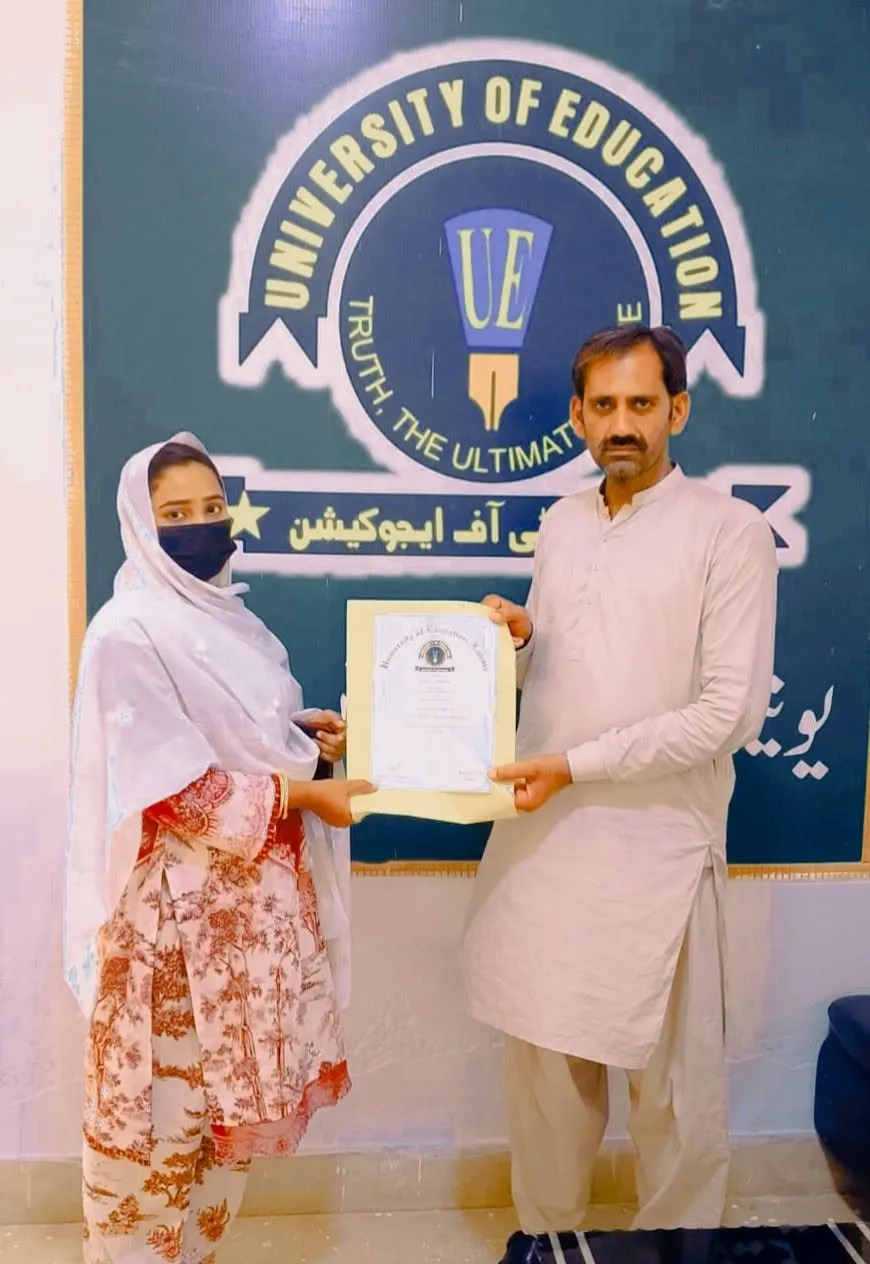 A graduate receiving her University of Education certificate from a member of staff
