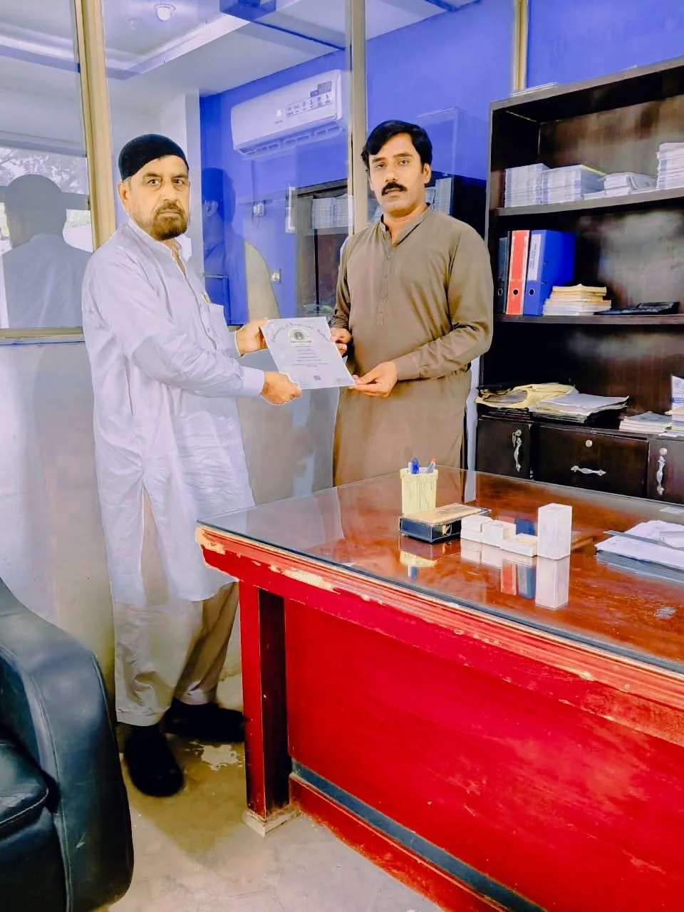 A University of Education certificate being handed over in the college office