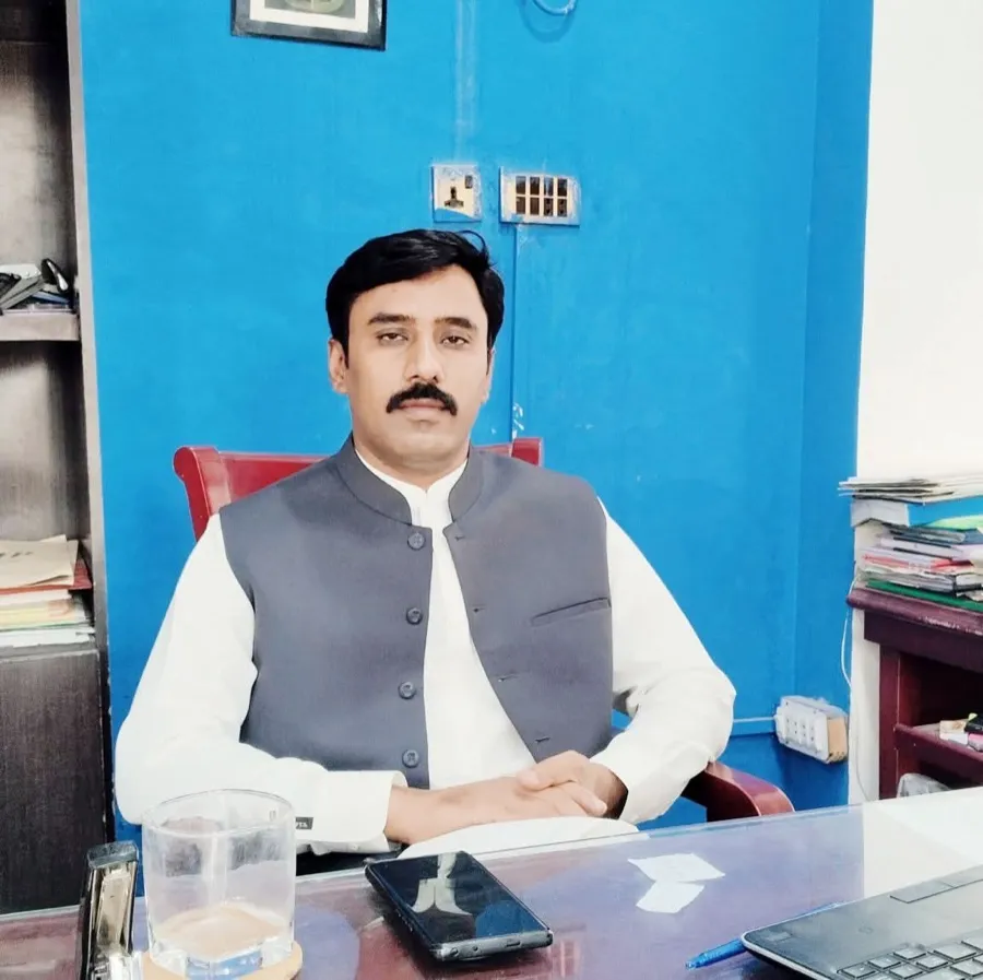 Hassan Raza, Principal of Alipur College, at his desk.